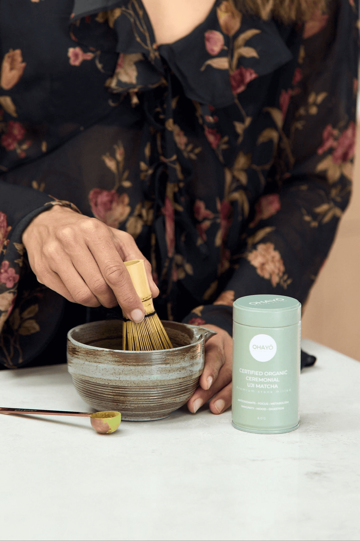 Ohayo Organic Ceremonial Matcha 60g, being whisked in a bowl, Scoop Wholefoods Cottesloe