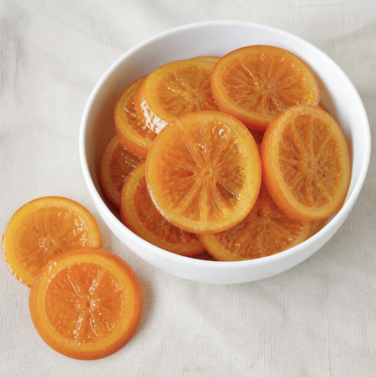 Orange Slices Glace, whole candied orange slices in a white bowl, Scoop Wholefoods Cottesloe