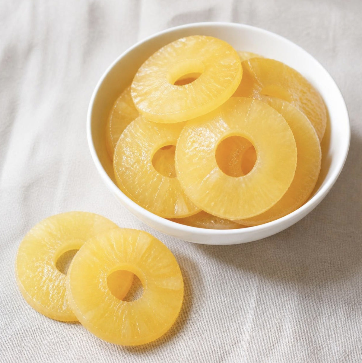 Pineapple Rings Glace, candied pineapple rings in a white bowl, Scoop Wholefoods Cottesloe