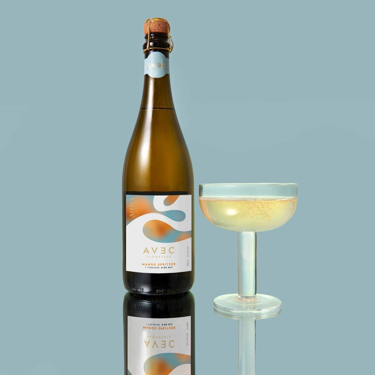AVEC FlowState Mango Spritzer 750ml, bottle beside a poured coupe, Scoop Wholefoods Cottesloe