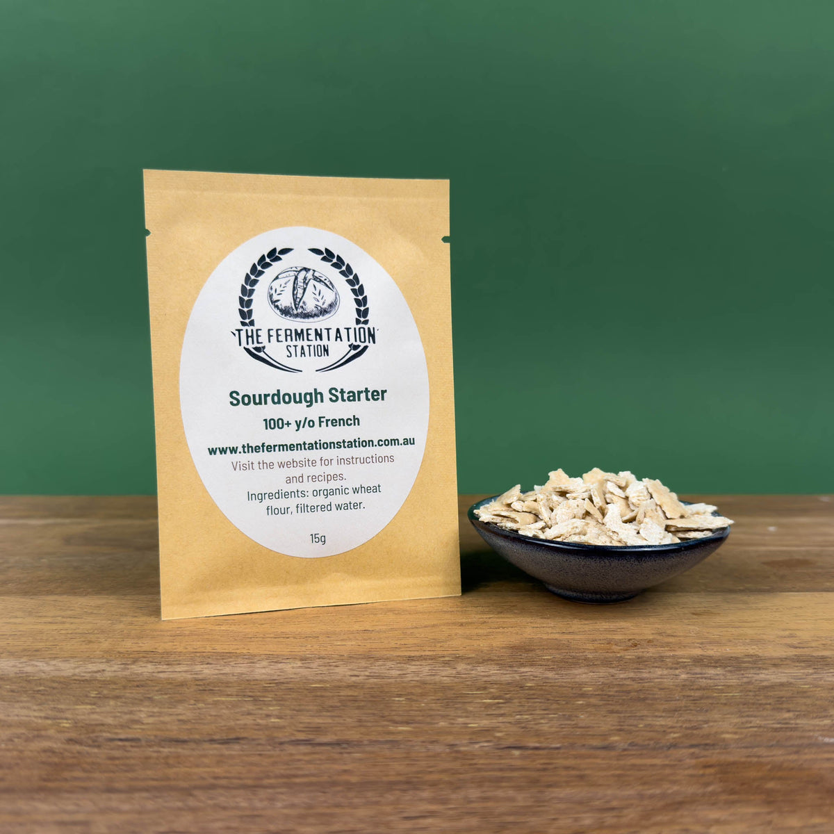 The Fermentation Station Sourdough Starter French Wheat 15g, pack beside a bowl of dried starter, Scoop Wholefoods Cottesloe