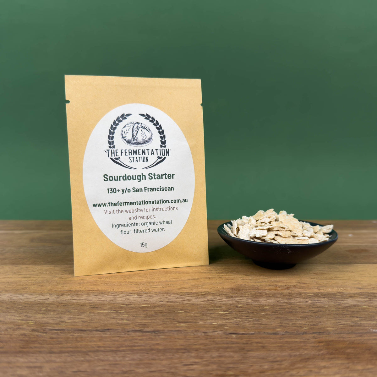 The Fermentation Station Sourdough Starter San Franciscan Wheat 15g, pack beside a bowl of dried starter, Scoop Wholefoods Cottesloe